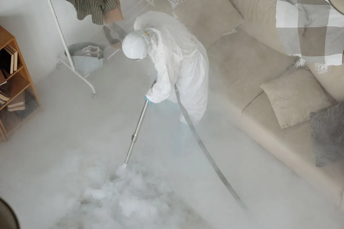 Biohazard cleanup technician in protective equipment, Milford city (balance), CT
